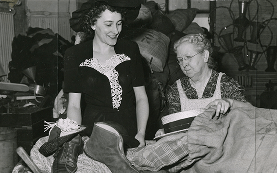 Photo of two women sorting donated clothing and apparel