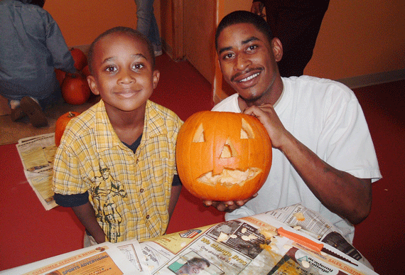 Photo of father and son carving pumpkins