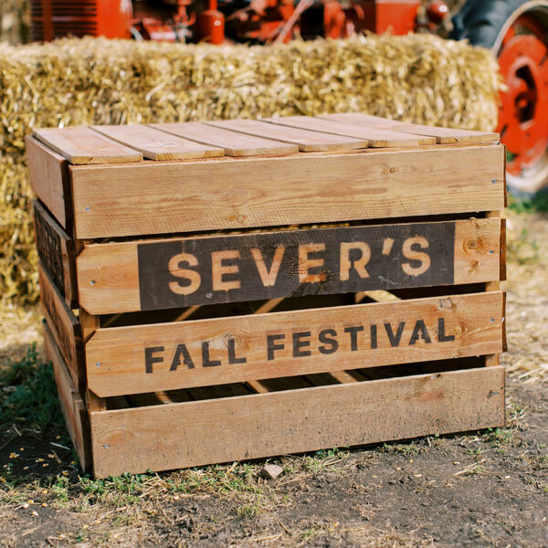 photo of a wooden crate with text spray painted on the side that states "Sever's Fall Festival"