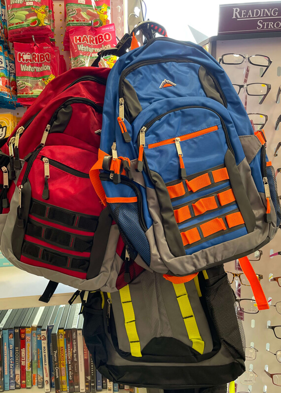 Photo of backpacks on hooks.