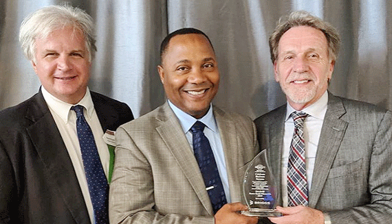Photo of President & CEO Michael Wirth-Davis and Chairman of the Board Jerome Hamilton accepting an award from the St. Paul Area Chamber of Commerce