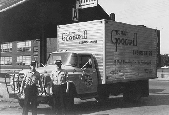 Photo of 2 Goodwill Employees in front a Goodwill truck 