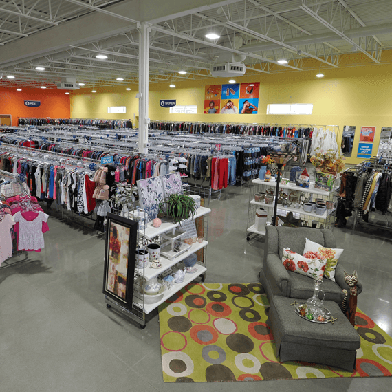 clothing racks, displays and furniture arrangement inside of the Goodwill store