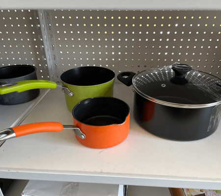 Photo of pots on a shelf.