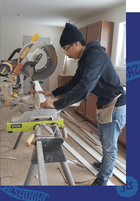 Photo of Adrian using a miter saw.