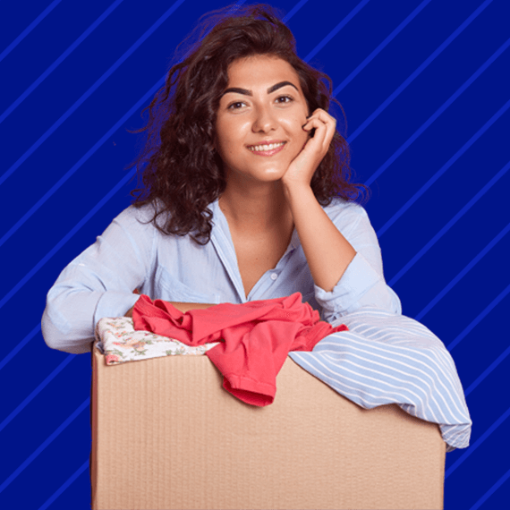 A female resting her arms on a box of donated clothing items