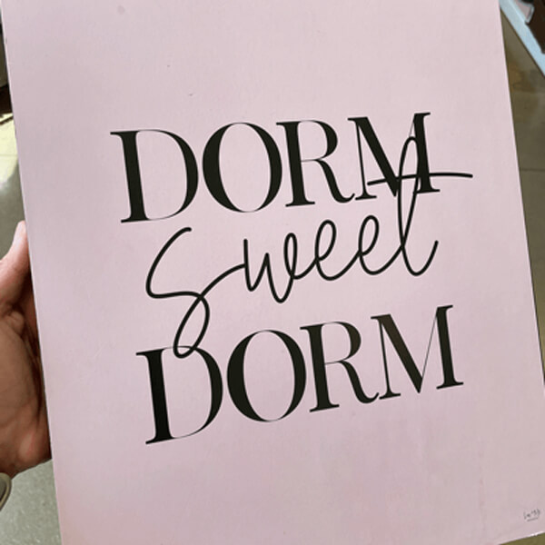 Photo of room decoration sign that states "Dorm sweet dorm."