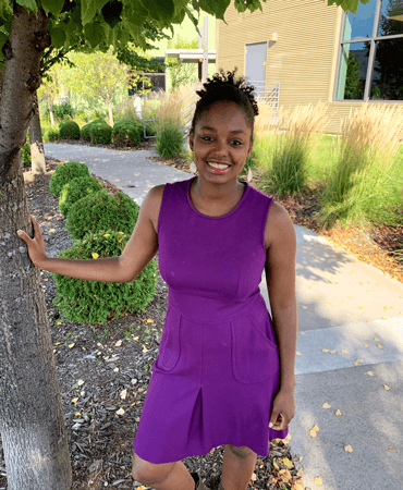 Photo of Romisha, GESMN Philanthropy Database Specialist wearing a purple dress.