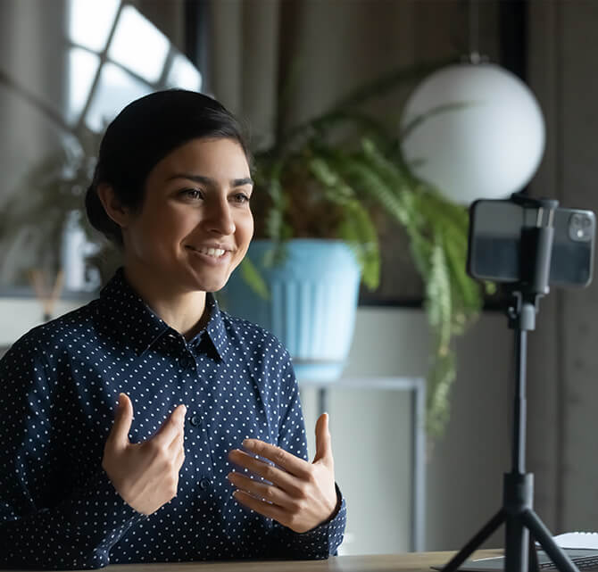 Woman smiling and on a video call.