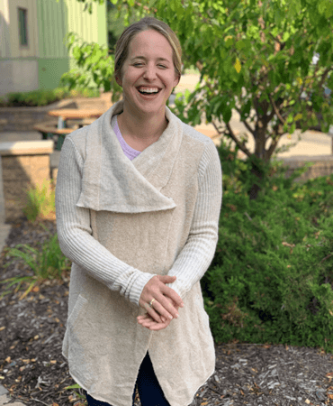 Photo of Molly, GESMN Career Navigation Specialist, wearing an asymmetrical neckline sweater.