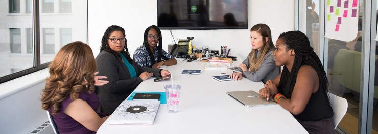 photo of a group of people meeting around a conference table