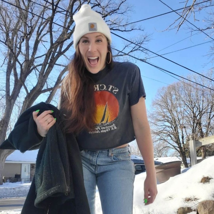 Photo of a person outside of the Chaske Wholesale Goodwill with a coat.
