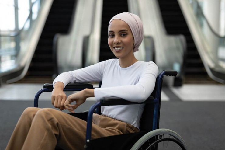 Photo of a woman in a wheelchair smiling.